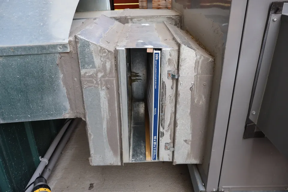 MERV 8 filter being fitted to an outdoor air-handler filter rack