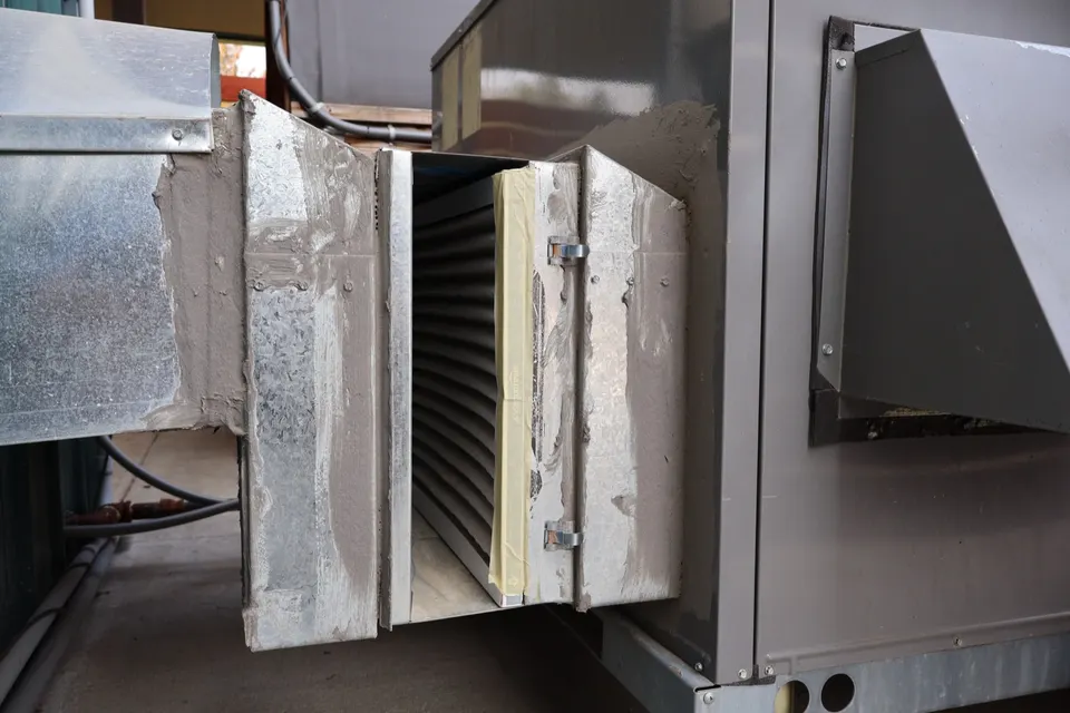 Opened filter rack on a residential air handler during a maintenance visit
