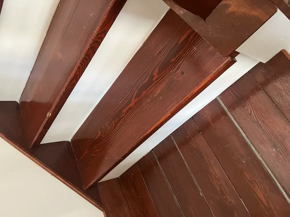 Refinished stair landing showing stained treads and painted risers